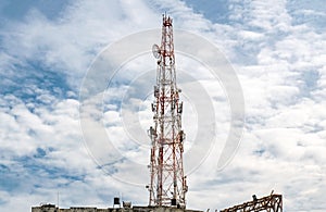 Tall Mobile Phone Tower, Celluar Tower with umbrella dish, attenuators, amplifiers and repeaters, installed on rooftop. photo