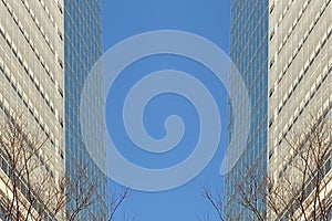 Tall office building in blue sky background with rising clouds