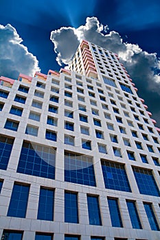 Tall office building and clouds on the sky