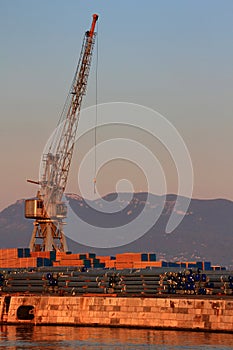 Tall old grey port crane in morning in Rijeka harbor Croatia