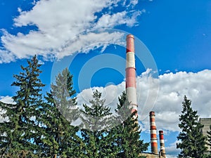 Tall pipes of a plant against a blue sky