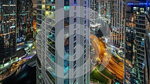 Tall residential buildings at JLT aerial night timelapse, part of the Dubai multi commodities centre mixed-use district.