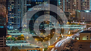 Tall residential buildings at JLT aerial night timelapse, part of the Dubai multi commodities centre mixed-use district.