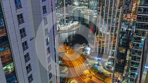 Tall residential buildings at JLT aerial night timelapse, part of the Dubai multi commodities centre mixed-use district.