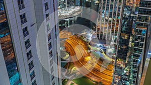 Tall residential buildings at JLT aerial night timelapse, part of the Dubai multi commodities centre mixed-use district.