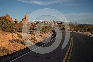 Tall Rock Formations Line The Curvy Road Of Arches