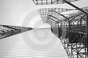 Tall rusty edifices featuring a complex network of wires. Duga is a Soviet over-the-horizon radar station for an early detection