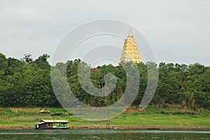 Tall Sacred Golden pagoda in Sangkalaburi province Thailand