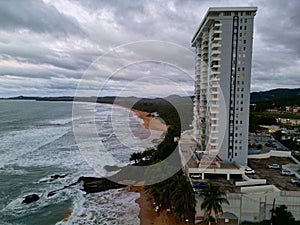 tall seaside residential buildings Luquillo, Puerto Rico (aerial drone view) downtown waves beach, mountains el yunque photo