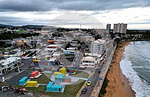 tall seaside residential buildings Luquillo, Puerto Rico (aerial drone view) downtown waves beach, mountains el yunque photo
