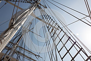 Tall ship rigging and shroud, masts and ropes against a blue sky