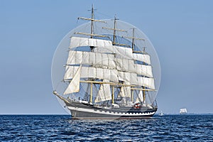 Tall Ship under sail with the shore