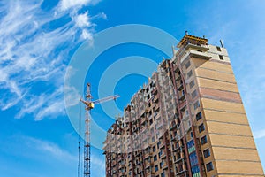 Tall skyscraper under construction with crane