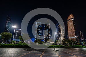 tall skyscrapers in the night light. View of modern city of abu dhabi. United Arab Emirates