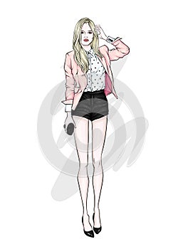 A tall slender girl in short shorts, a jacket and high-heeled shoes. Beautiful model in stylish clothes.