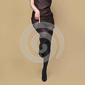 Tall slim female legs in tights. Pantyhose with prints