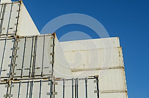 Tall stacks of white shipping containers