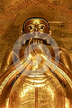 Tall standing golden Buddha showing Dharmachakra Mudra, Gesture