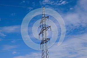 Tall steel electrical or hydro tower in low angle perspeective. blue sky