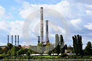 tall steel industrial smoke stacks. old, decommissioned powerplant. blue sky and white clouds.