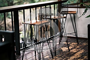 Tall table - Wooden table steel legs simplistic, tall bar stools in stylish kitchen with wooden cupboards.