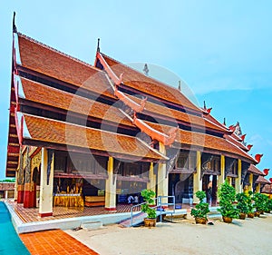 Three-tired pyathat roof of Viharn Luang in Wat Phra That Lampang Luang Temple, Lampang, Thailand photo