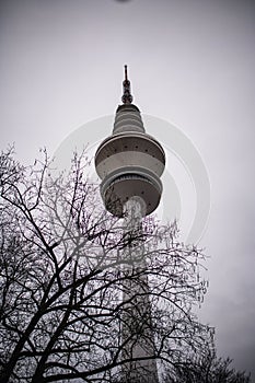 the tall tower is made from metal and has a circular skylight