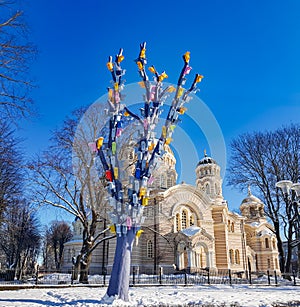 Tall tree with many colorful birdhouses