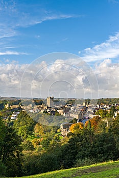 Tall view of Richmond, North Yorkshire and the castle with blue skies and fluffy clouds