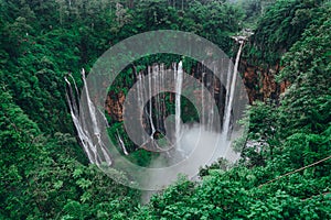 Tall waterfall in the middle of a forest on Java Island