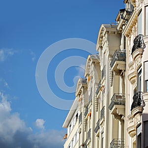Tall white building with balconies