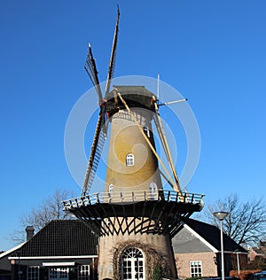 Tall windmill in krimpen aan den ijssel along river Hollandse IJssel