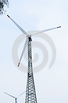 Taller hybrid tower lattice wind turbine build of rolled steel tubular segmented install high up 200 feet over land with 100m