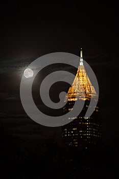 Tallest building in Atlanta downtown in the night with full moon