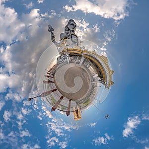 tallest hindu shiva statue in india on mountain near ocean on little planet in blue sky with evening clouds, transformation of