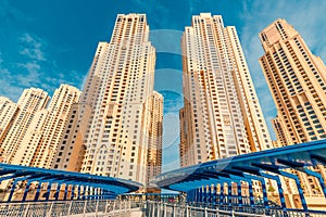 tallest residential block in the world - Jumeirah Beach Residence and original architecture pedestrian bridge in Dubai.