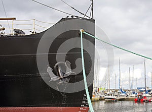 Tallinn, Estonia, August 2018. Ship`s nose, metal anchor and cable for mooring vessels close-up.