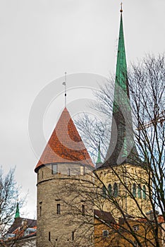 Tallinn, Estonia: Autumn landscape with a view of the Church of St. Olaf. Old Fortress tower with red roof