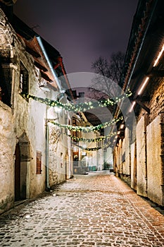 Tallinn, Estonia, Europe. St. Catherine`s Passage At Winter Evening In Night Illuminations. Narrow Medieval Street