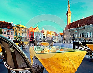 Tallinn , Estonia  Glass of red wine on table top in  old town hall square street cafe  sunny day  blue sky in city  medieval hous