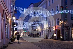 TALLINN, ESTONIA - JANUARY 12, 2018: Night picturesque winter view of the old streets with Christmas decoration in the historical