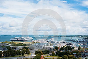 TALLINN, ESTONIA - JULY 22, 2015: Aerial panoramic view of Tallinn old town city center and port with big cruise ships on cloudy