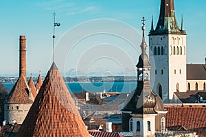 Tallinn, Estonia. Part Of Tallinn City Wall With Towers, At The Top Of Photo There Is Tower Of Church Of St. Olaf Or