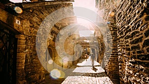 Tallinn, Estonia. People Tourists Walking In St. Catherine's Passage From St. Catherine's Dominican Monastery At