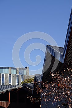 Tallinn, Estonia - September 26, 2021: View to interesting unusual shape diagonal roof and facade of the grey building