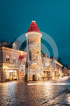 Tallinn, Estonia. Tower Of Viru Gate In Street Lighting At Evening Or Night Illumination. Towers In Christmas Holidays