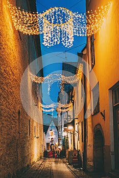 Tallinn, Estonia. View Of Raekoja Street In Christmas New Year Xmas Festive Illumination Lights And Decorations