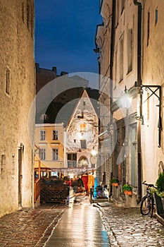 Tallinn, Estonia. View Of Raekoja Street With Old Ancient Medieval Houses In Evening Night Lights. Beautiful Old Narrow
