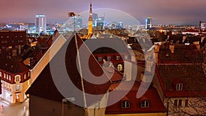 Tallinn old town at blue night full moon on blue sky blurring light on city horizon panorama