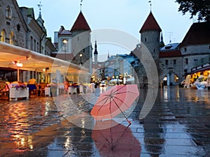 Tallinn  Old Town night   city light  pink umbrella  rainy season street evening lightening  blurring bokeh city  people walking